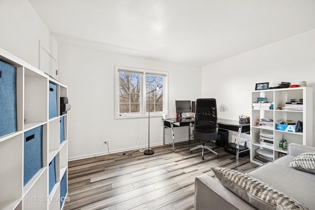 bedroom with baseboards and wood finished floors