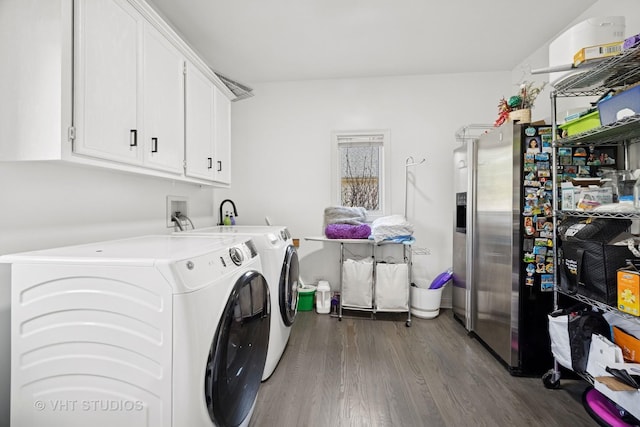 washroom featuring cabinet space, dark wood-type flooring, and independent washer and dryer
