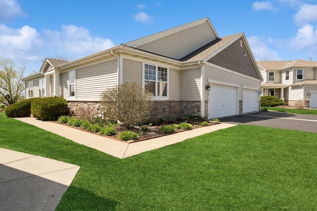 view of home's exterior featuring a garage, driveway, a yard, and stone siding