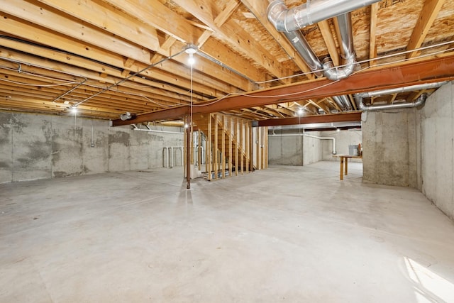 unfinished below grade area featuring stairs and water heater