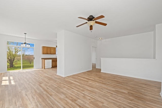 unfurnished living room featuring baseboards, light wood-style flooring, and ceiling fan with notable chandelier