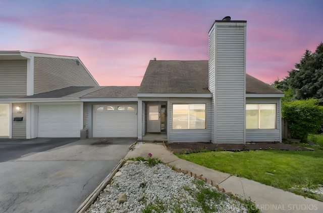 516 Gardiner Ct, Romeoville, IL 60446 - view of front of home featuring an attached garage, driveway, a chimney, and a front lawn