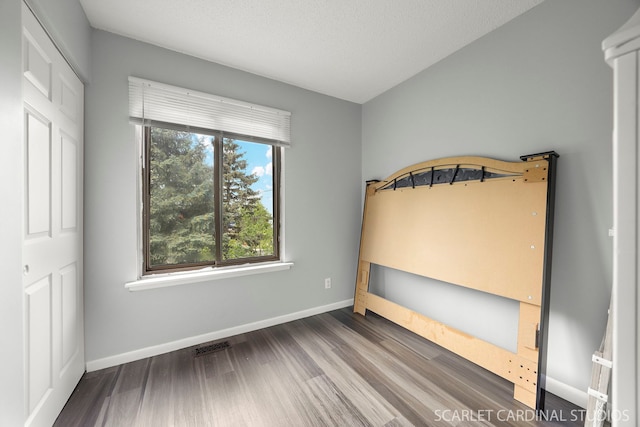 516 Gardiner Ct, Romeoville, IL 60446 - unfurnished bedroom with wood finished floors and baseboards