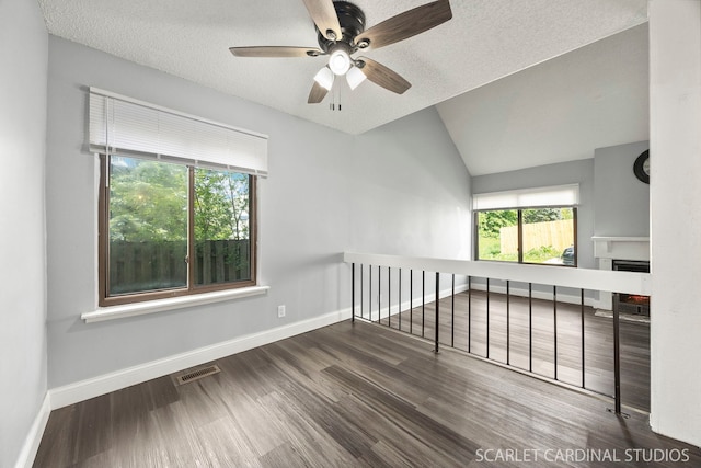 516 Gardiner Ct, Romeoville, IL 60446 - spare room featuring a ceiling fan, wood finished floors, baseboards, a fireplace, and vaulted ceiling