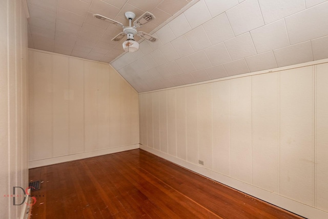 bonus room with visible vents, dark wood finished floors, a ceiling fan, baseboards, and vaulted ceiling