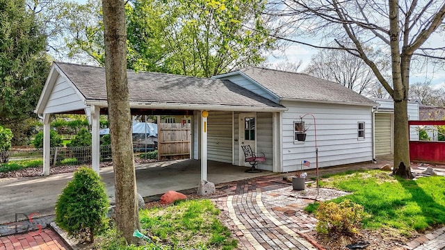 view of outbuilding with fence