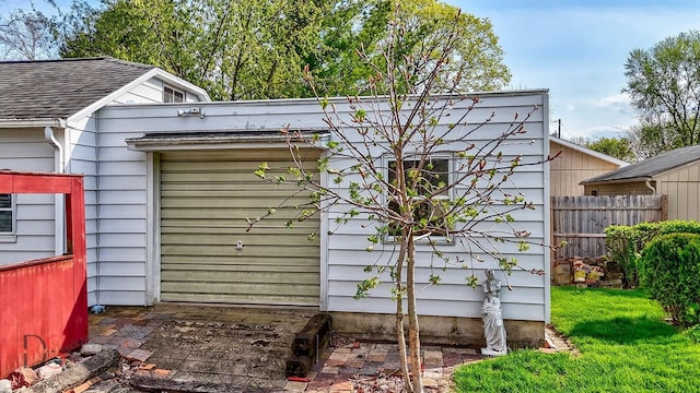 view of outbuilding featuring fence