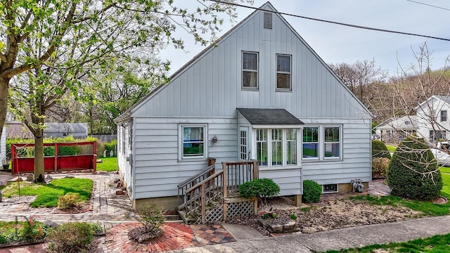 back of property featuring a shingled roof