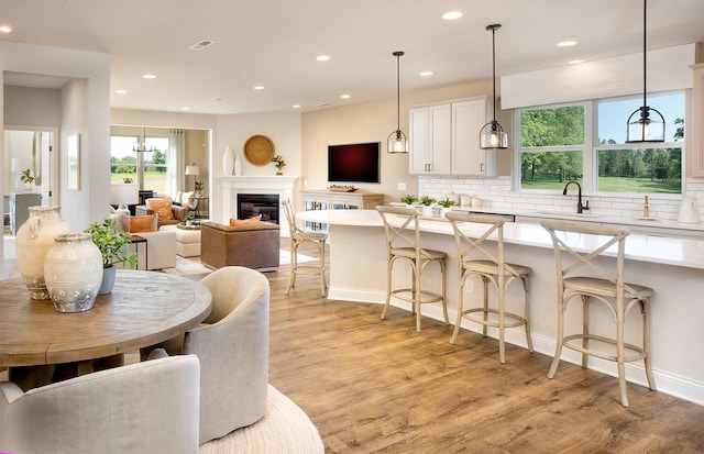 274 Branson Dr, Batavia, IL 60510 - dining space with light wood-type flooring, recessed lighting, and a glass covered fireplace