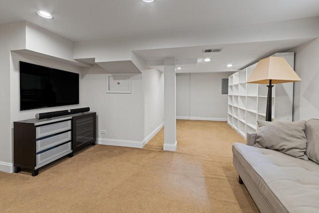 finished below grade area featuring baseboards, visible vents, and light colored carpet