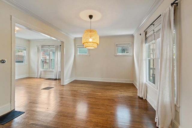 unfurnished dining area featuring wood finished floors, baseboards, and crown molding