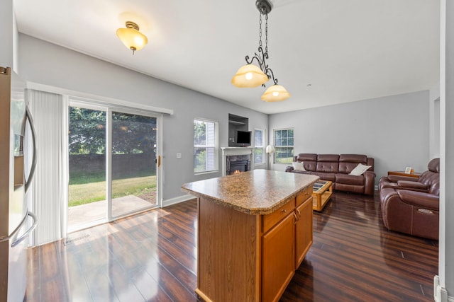 1844 Candlelight Cir, Montgomery, IL 60538 - kitchen featuring stainless steel fridge with ice dispenser, open floor plan, dark wood-style flooring, and a kitchen island