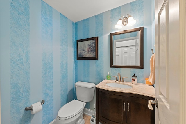 1844 Candlelight Cir, Montgomery, IL 60538 - half bath featuring wallpapered walls, vanity, and wood finished floors