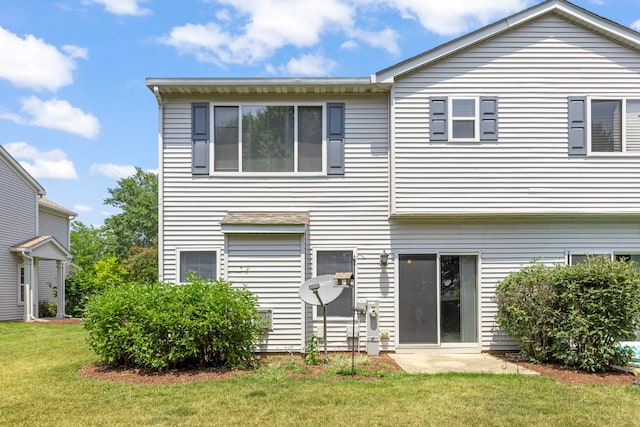 1844 Candlelight Cir, Montgomery, IL 60538 - rear view of property with a lawn