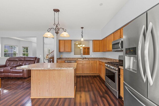 1844 Candlelight Cir, Montgomery, IL 60538 - kitchen with stainless steel appliances, dark wood-style floors, open floor plan, a kitchen island, and light countertops