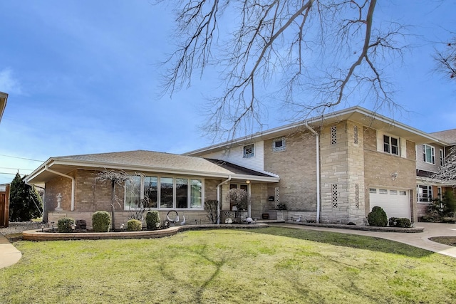 split level home featuring an attached garage, stone siding, brick siding, and a front yard