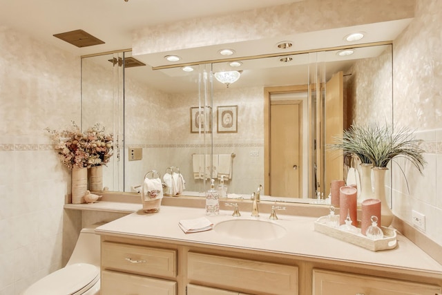 bathroom featuring tile walls, toilet, and vanity
