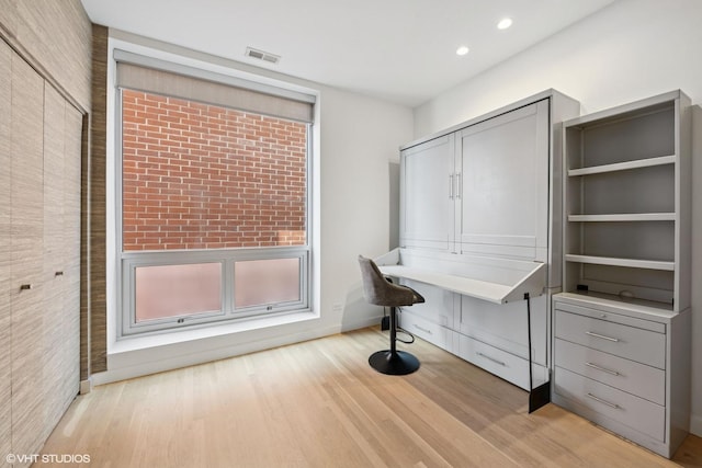 unfurnished office featuring baseboards, recessed lighting, visible vents, and light wood-style flooring