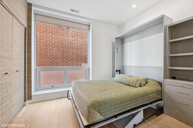 bedroom with visible vents and light wood finished floors