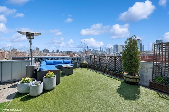view of yard with a city view, fence, and an outdoor living space