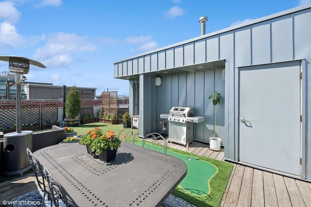 deck featuring grilling area and fence