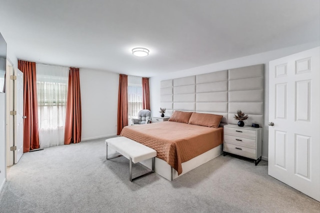 bedroom featuring light colored carpet