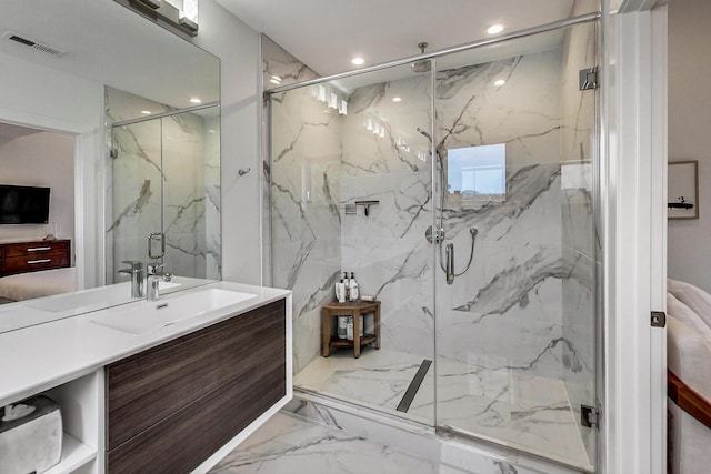 full bath with a marble finish shower, visible vents, recessed lighting, marble finish floor, and vanity