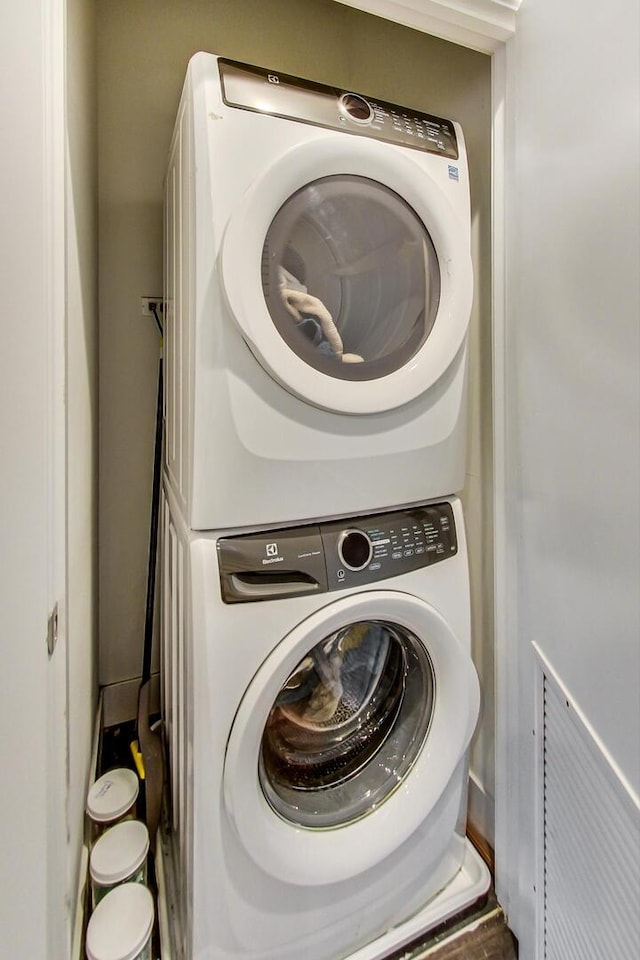 washroom with stacked washer / dryer and laundry area