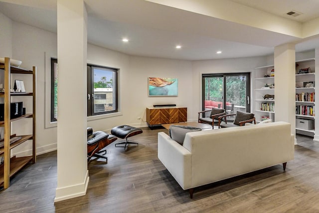living room featuring recessed lighting, plenty of natural light, baseboards, and dark wood-style flooring