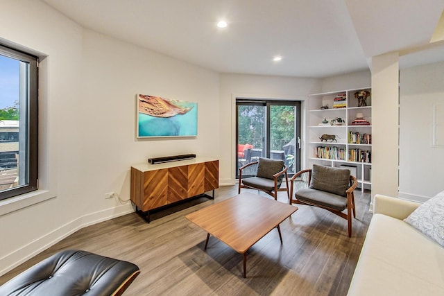 living area with recessed lighting, baseboards, and wood finished floors
