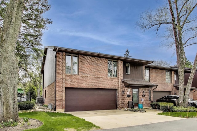 view of front of home featuring brick siding, a garage, and concrete driveway