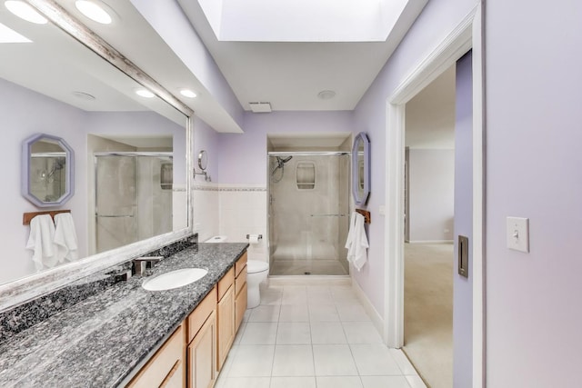 full bath featuring vanity, tile patterned floors, a stall shower, and toilet