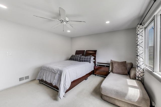 carpeted bedroom featuring visible vents, recessed lighting, a ceiling fan, and multiple windows