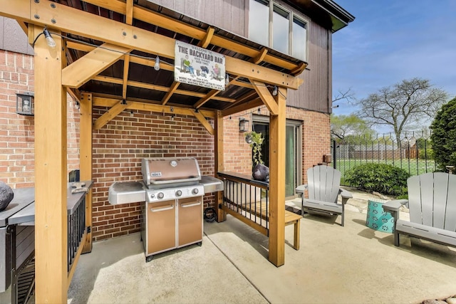 view of patio with a gazebo, fence, and a grill