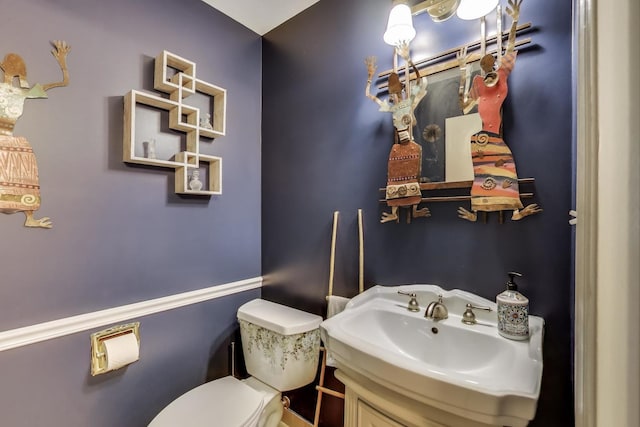 half bathroom with vanity and toilet