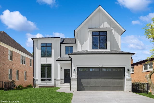 modern farmhouse with a front lawn, driveway, board and batten siding, fence, and a garage