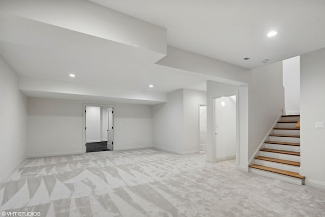 finished below grade area with recessed lighting, baseboards, stairs, and light colored carpet