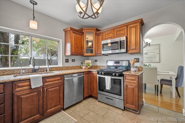 kitchen featuring a sink, appliances with stainless steel finishes, and brown cabinetry