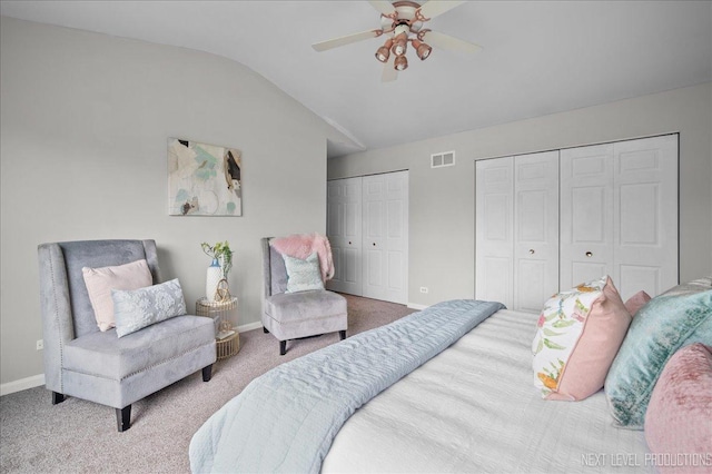 bedroom featuring carpet flooring, multiple closets, visible vents, and baseboards
