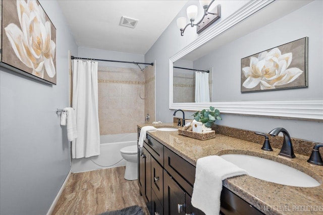 full bathroom featuring visible vents, a sink, wood finished floors, and toilet