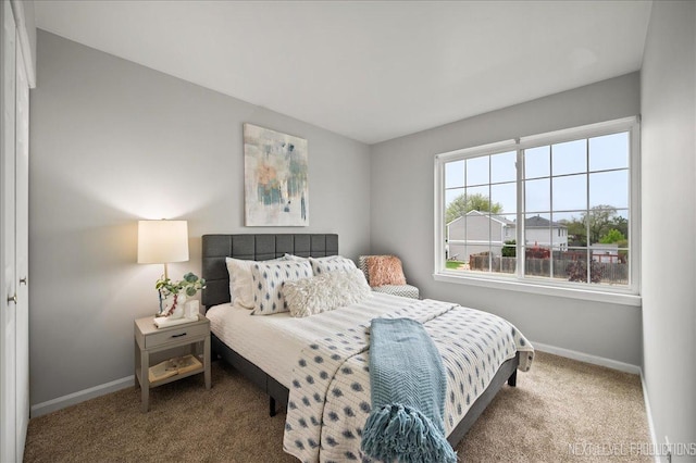 bedroom featuring carpet floors and baseboards