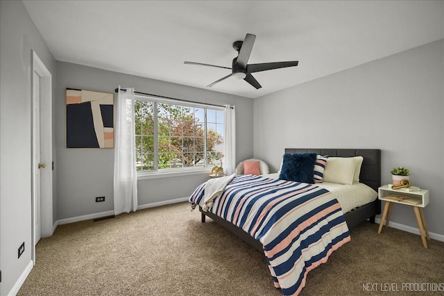 carpeted bedroom featuring baseboards and a ceiling fan
