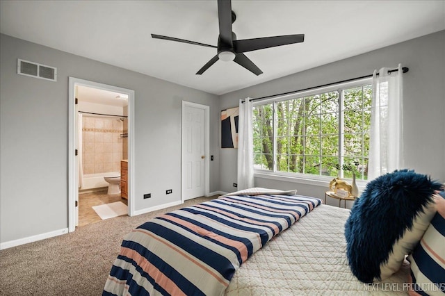 carpeted bedroom featuring baseboards, visible vents, ceiling fan, and ensuite bathroom