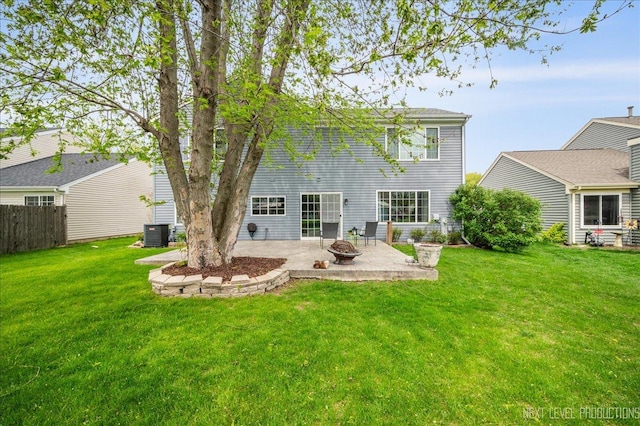 back of house with fence, an outdoor fire pit, cooling unit, a lawn, and a patio