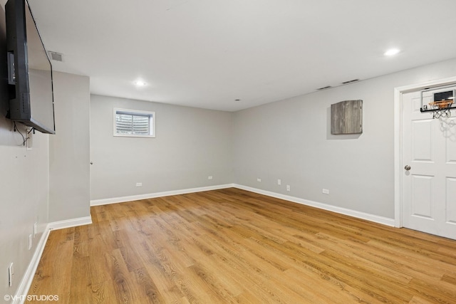 below grade area with recessed lighting, light wood finished floors, and baseboards