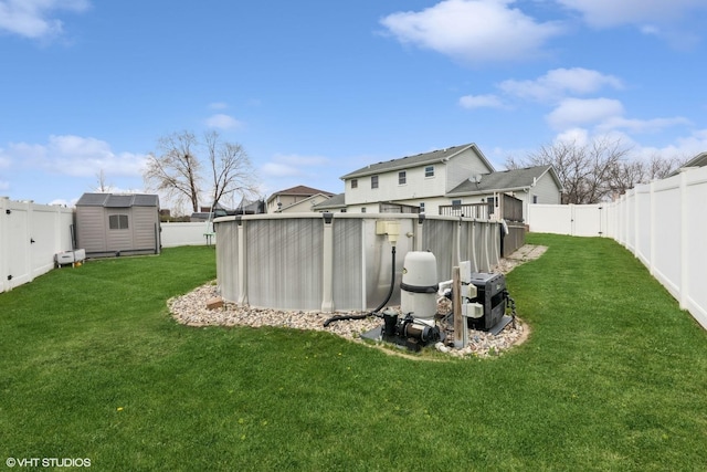 view of yard with a fenced backyard, an outdoor structure, and a storage shed