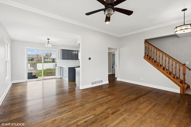 unfurnished living room featuring visible vents, stairs, dark wood-style flooring, and ceiling fan with notable chandelier