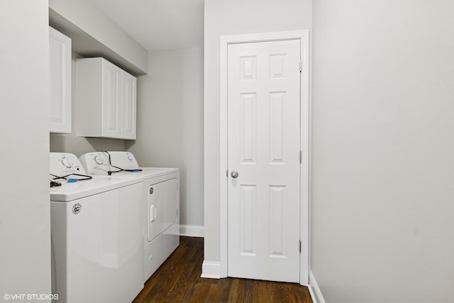 clothes washing area featuring baseboards, cabinet space, washer and clothes dryer, and dark wood-type flooring
