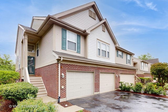196 Tyler Ct, Lake Zurich, IL 60047 - view of home's exterior featuring an attached garage, brick siding, and asphalt driveway