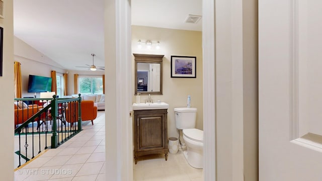 196 Tyler Ct, Lake Zurich, IL 60047 - bathroom with a ceiling fan, toilet, vanity, tile patterned flooring, and vaulted ceiling